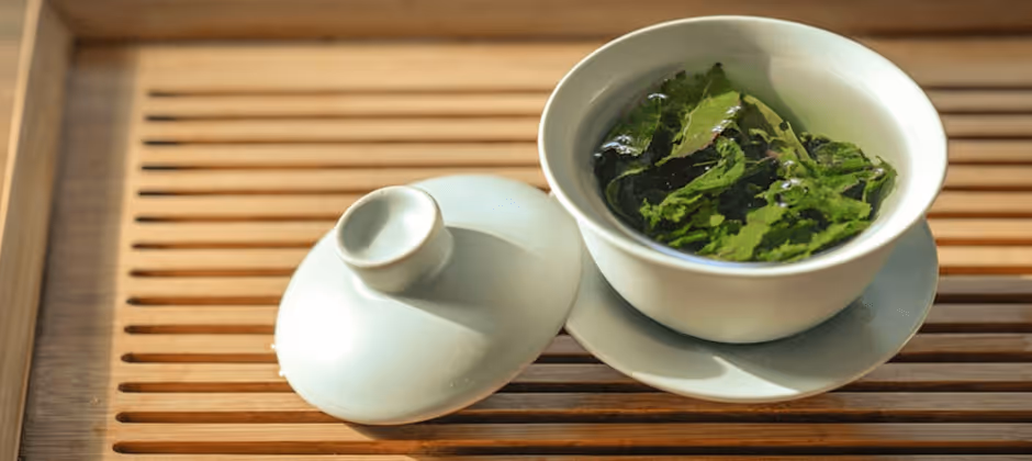 wooden trey with tea leaves in a white cup